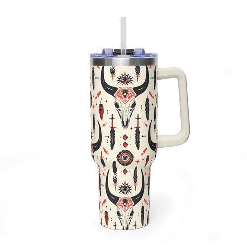 A handleless tumbler with a straw, decorated with a southwestern pattern featuring a central bull skull, feathers, and geometric designs on a cream background.